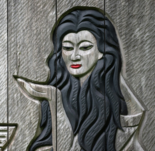 A statue of a woman with long black hair