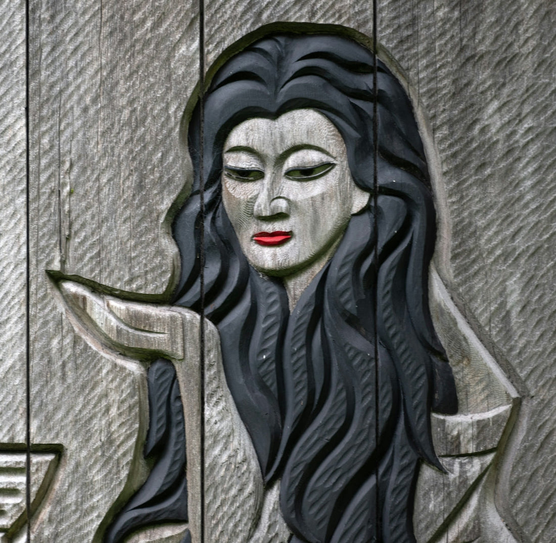 A statue of a woman with long black hair