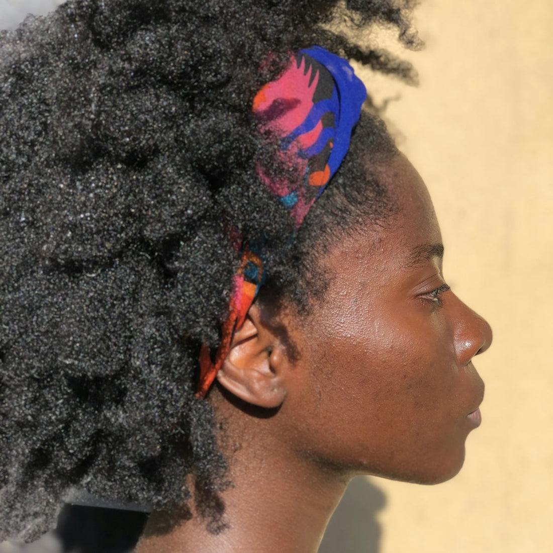 A close up of a person with an afro