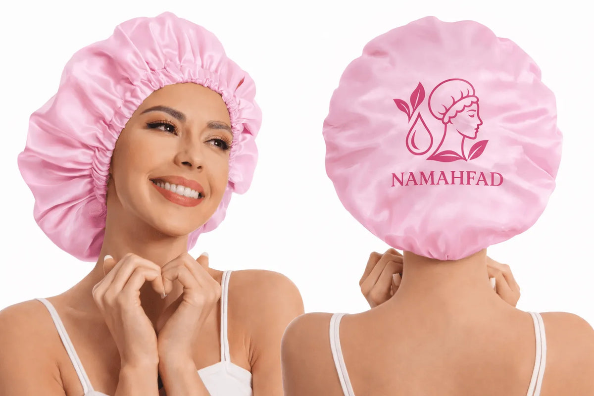 Pink satin sleep bonnet back view with NAMAHFAD logo on circular panel