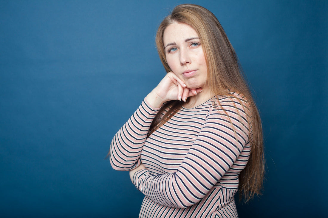 a woman with her hand on her chin