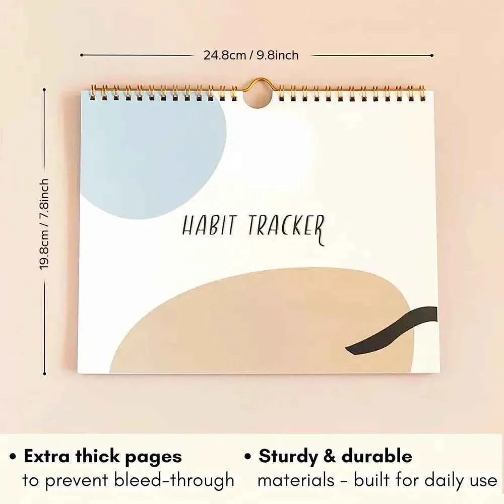 Spiral-bound undated habit tracker planner cover with gold ring binding and hanging loop