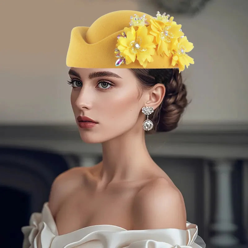 Yellow African Headtie Turban Hat adorned with flowers and embellishments, worn by a woman with elegant makeup and earrings.