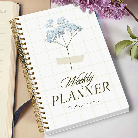 Undated weekly planner notebook, white cover with blue tree graphic and gold coil binding