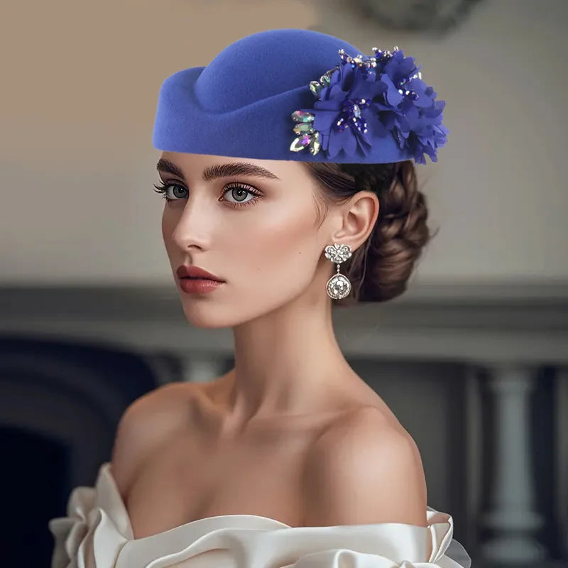 African Headtie Turban Hat for Women in blue with floral embellishments, worn elegantly by a woman in a stylish setting.