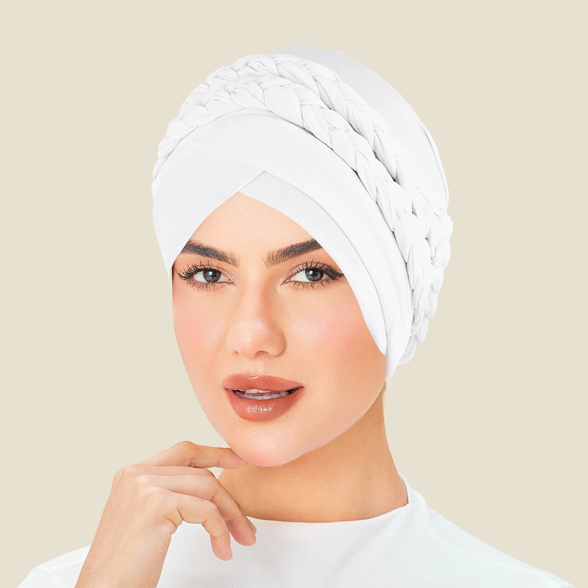 White solid color turban bonnet hijab cap with braided design, worn by a woman, showcasing elegance and style.