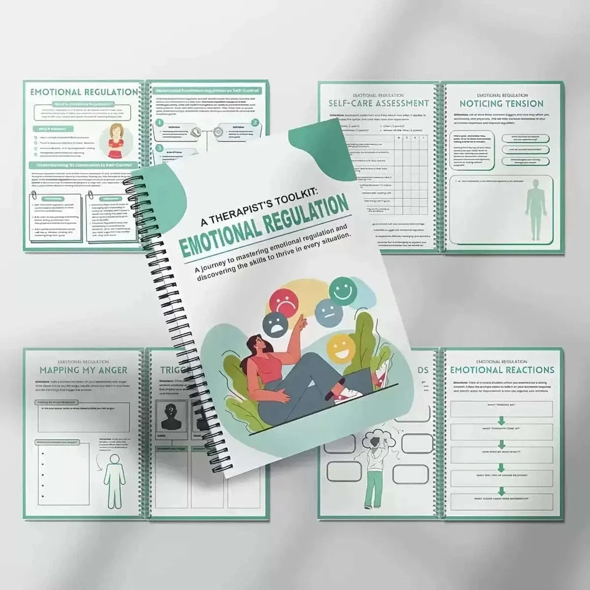 Spiral-bound emotional regulation workbook surrounded by multiple worksheet pages and charts.