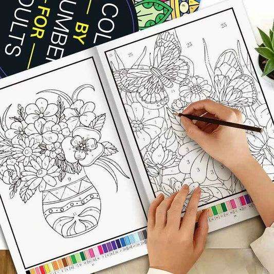 Adult coloring book page with black-and-white floral mandala; hands adding color.